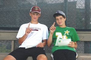 Above: Coming in first in the boys' 14 doubles championship game was Joe Lipovetz (left) of Golden Valley and Pete Summers of Grand Marais. Right: David Bergstrom was all business in the Fisherman’s Picnic tournament. Bergstrom, whose headed to college soon where he will play Division I tennis, won the mens' open singles crown against a talented field.