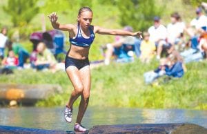 Left: Rielly Wahlers, Grand Marais, shows the form of a young boom runner trying to balance her way on the wet logs. Above: Shana Martin displays the form of an experienced boom runner as she sprints her way down the logs. Shana is from Madison, Wis., and is the reigning 2012 women’s log rolling world champion.