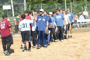 The Grand Portage Rendezvous Days Mixed Softball Tournament saw lots of great ball and friendly competition. Above: Team Grand Portage and Higher Mark Construction shared high-fives at the end of their game. Both teams have players from throughout the county and have faced one another many times on the diamond. Right: Another team with mixed membership is Team Murray, which has a number of local players and others from Cloquet, MN. Team Murray was undefeated in the 2012 Rendezvous Days Tournament. Tanner Murray was powerful at bat for his team.