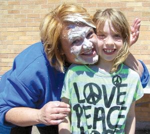 Last spring, Birch Grove Community School had a special end-of-year event, which included fun sporting events, a tug-of-war—and a pie in the face for Birch Grove Director Diane Blanchette. It was all part of the reading incentive program at Birch Grove. Students get a ticket for each book they read. At the end of the year a drawing is held and the student who read the most books gets a prize. Winner Savana Merritt got to pick anyone at Birch Grove—teacher or staff—to hit in the face with a cream pie! Savana chose Blanchette—who showed her “appreciation” by giving Savana a nice creamy hug! The competition will start anew as Birch Grove students head back to the classroom September 4.