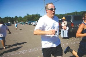 There were 418 participants in the 2012 Grand Portage Rendezvous Days Walk Run. Above left: Coming across the finish line first in his age division was Tim Scannell of Grand Marais who completed the three-mile race in 21:59. Above right: Joy Carlson and Arline Johnson were the 1st and 2nd place finishers, respectively in their age division in the 1-mile walk. They looked like they were having a great time.