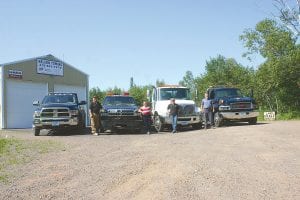 The Cook County Towing crew with some of the fleet of trucks to be used for roadside assistance and recovery. The trucks (L-R) are a 1994 Dodge 1-ton, 2011 Dodge 5500, 2004 International 4300 and 2009 GMC 5500. The people who will be driving the wreckers are (L-R) Paul James, Lisa Mesenbring, Pam James and Jay Mesenbring.