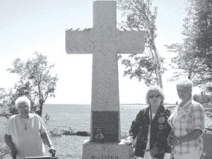 A group of Grand Portage Elders made the trek to Schroeder to attend the rededication of Father Baraga’s cross at Cross River on Sunday, August 5. Standing at the beautiful cross site are (L-R) Bernice LeGarde, Ellen Olson, Joy Carlson.