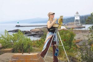 Last year 45 artists traveled from all over the region to take part in the Grand Marais Art Colony Plein Air competition and exhibition. Above: Holly Johnson-Beaster, of Duluth and formerly of Grand Marais, was one of the artists. She was the picture of concentration during the Quick Paint competition. Right: Matt Kania of Duluth earned honorable mention for his oil painting of the ever-changing rock cairns at the Point during the Quick Paint Competition. Look for plein air artists around the community beginning September 7. The exhibit of plein air works will open at the Art Colony on September 14.