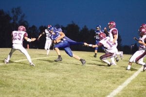 Left: Kale has a tail? Not quite. Viking quarterback Kale Boomer didn’t slow down much for this grab at his uniform by the Two Harbors defender as he romped into the end zone to score 6 points at the home game on Friday, August 31. Below left: Using his tremendous speed, Peter Warren (No. 33) blasts around the end on his way to an 80- yard touchdown run. Below: With the Two Harbors players trailing far behind him, Colin Everson ran for huge yardage on this play. Everson scored 4 touchdowns on the day, and was named Viking offensive player of the week by the coaches.