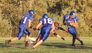 Above: Saturday night fever anyone? Mark Marxen throws in a little “dance” move to make the defender miss as he jitterbugs his way down the field on his way for a nice gain. Both Kale Boomer (11) and Jacob Schroeder (16) helped to clear a path for Marxen who rushed for 27 yards against Ogilvie. Right: Thomas Anderson carried the ball for 13 yards against Ogilvie. On this run Richie Furlong looks to block for him.