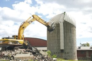 It didn’t take long to knock down the silo at the school last Friday, September 14. The silo was used to store wood chips that at one time were burned to heat the school. The biomass heating plant was closed in the mid 1980s because too much smoke was generated throughout town when the plant was in use. The silo was taken down to accommodate the proposed community center.