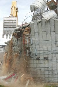 Workers were surprised to find wood chips—or what is left of decomposed wood chips—still left in the silo. A good many pigeons were also displaced when the silo came down. Some waited until the silo was half down before flying away.