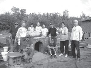 It takes a village to build a hearth oven. In this case the village consists of the HOBBITs—the hearth oven bread baking initiative team. The folks who participated in the hearth oven construction course were (seated in front) Instructor Derek Lucchese, Gerry D’Amour. (L-R, back) Eric Frost, Heidi Boehlke, Trevor Huggins, Jan Horak, Matt Kartes, Art Dykstra, Jeanne Larson, Bill Huggins.