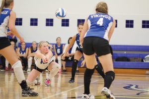 Above: With three Viking players looking on, Anna Carman digs the ball off the floor and bumps it to her setter. Far right: Taylor Ryden grabs a piece of the sky as she goes up high to spike the ball against Moose Lake. Right: Ali Iverson blocked the spike attempt on this play against Moose Lake. The girls are now 5-1 on the year.