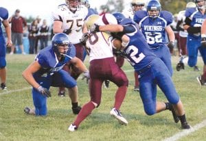 Upper left: Colin Everson (12) wrapped up the Barnum ball carrier while Jacob Schroeder, on one knee, gets ready to finish off the play. Above: With Colin Everson and Jacob Schroeder blocking, Viking quarterback Kale Boomer runs through a Barnum tackler’s grasp for a nice gain. Left: He’s not very big, but Mark Marxen is a great tackler. Here he slams a Barnum ball carrier into the turf.