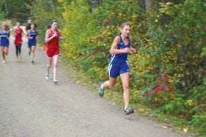 Upper left: Just a seventh grader, Maya McHugh has improved enough to make the girls' varsity cross country team. Above: Will Seaton led teammate Sean MacDonell by two steps at the Eveleth Invitational. Left: Joey Chmelik races a runner from Virginia to the finish line. The boys' teams placed 6th out of 18 teams, while the girls' team placed 4th out of 18 teams at Eveleth.