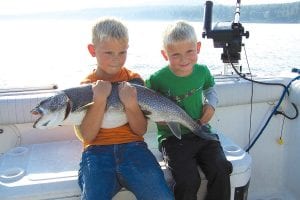 Trevor Wilcox holds his brother Ty’s lake trout caught while fishing with Captain Darren Peck of Tofte Charters on August 24. The big trout was 37½ inches long and weighed in at 18 pounds. Ty is just 44 inches tall. The boys are from Rochester, MN.