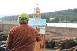 The Grand Marais Art Colony hosted Plein Air Grand Marais last week and 53 artists took part in activities like the Quick Paint competition on Thursday, September 13. Lee Englund of Duluth chose the Grand Marais lighthouse as his subject. See more about Plein Air Grand Marais on page A3.