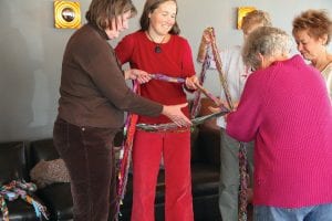 Left: Braiding sections of yarn that span the width of a room is much easier when people work together, and working together was part of the purpose of the event: to foster an understanding of the usefulness of cooperation and collaboration.