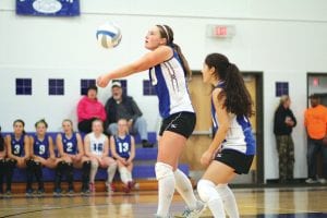 Top: With Sarah Deschampe watching, Megan Lehto bumped the ball to one of her front court teammates. Above: Lexi Palmer set the ball nicely on this play and had a good all around game against Wrenshall. Left: Going up high and with the eye of the tiger, Stephanie Lashinski spiked the ball back against Wrenshall.