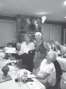 The Cook County Tennis Association held its annual meeting at Devil Track Landing in August. Several tennis association members were honored for the role they play in the tennis community. Frankie Jarchow (left) was presented a certificate of appreciation for her support of CCTA programs for 20 years. Presenting the award is Kathy Bolstad.