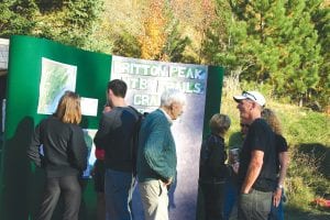 Former Lutsen ski hill and Lutsen Resort owner George Nelson (front center in sweater) was one of many people on hand for the celebration commemorating the opening of the single track mountain biking trails at Britton Peak on Saturday, September 29. There are now three interconnecting trails open to bikers/hikers: an expert loop, a beginner loop and an intermediate loop. If all goes well with a current proposal for a Legacy Grant, as many as 17 more miles of trail will be built in the next couple of years and will connect with the ski hill built and founded by George and his wife, Patti.