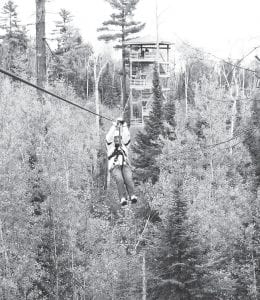 On Wednesday, September 19, seniors headed to Gunflint Lodge for a delicious lunch and a wonderful, scenic and thrilling Gunflint Pines Canopy Tour. The tour lasted about two hours. Only four of the Cook County Senior Center group of nine completed the tour. Pictured zipping along is the oldest and best sport of the day, Jo Tupper, age 78.