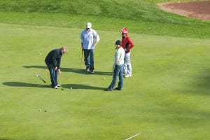 All eyes are on the putt Seth Williams rolled toward the hole. It just missed by an inch. Watching with keen interest were sisters Samantha Williams, Stephanie (Williams) Radloff, and brother-in-law Gary Radloff.