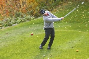 Left: Superior National Assistant Pro Andy Smith shows off the form that helped him win the state assistant golf professional championship recently held in Duluth. Smith helped with the North Shore Health Care Golf Tournament on October 7, hitting tee shots for people on a difficult hole in the Canyon section of the golf course.