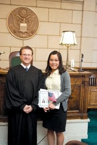 Magistrate Judge Leo I. Brisbois congratulates Thuy Meinz at the end of the Naturalization Ceremony in Duluth on September 24.