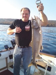 Craig Schulte of Grand Marais shows off his very nice end-ofseason catch, a 14.9-pound lake trout caught near Artist Point in Grand Marais on October 3.