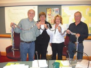 Grand Marais resident Karen Lohn, author of Peace Fibres: Stitching a Soulful World, gave the county board a braided scarf made by community members. “This scarf is part of a project to celebrate the International Day of Peace,” Lohn wrote to the board, “and to honor your work and achievements toward sustainable peace between and among all people. The scarf was braided by many hands, using strands blessed with peaceful intentions, contributed by diverse peoples from six continents. May you enjoy its beauty and unity of spirit or re-gift to encircle another with warm wishes for peace and harmony.” Accepting the scarf are (L-R) commissioners Bruce Martinson, Sue Hakes, Jan Hall, and Fritz Sobanja.