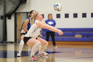 Above: In perfect position, Anna Carman bumps the ball to a teammate. Carman was not only a heady player for the Vikings this fall, but was also one of the steadiest players game in and game out for her team. Far right: Going up high, Theresa Morrin blocked this spike attempt by a Cromwell player in the Vikings' last game of the year. Right: Sarah Deschampe made some of the best digs ever seen by Viking fans in the game against Cromwell. Not the tallest player, Deschampe made great use of her quickness and was fearless in her play in the backcourt.