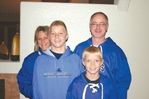 With two good looking, eager beaver children ready to help at a moments notice; it was an easy decision for Terri and Chris Goettl to become partners in the Arrowhead Pharmacy business when the opportunity presented itself. Smiling broadly with their parents behind them are Luke, age 10, and Leo, age 15.