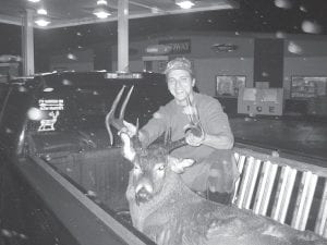 Left: Jed Smith of Grand Marais is not in the running for one of the prizes in Buck’s Big Buck Contest, but he got a buck to be proud of. It weighed in at 230 pounds and it too, has an interesting rack with an interesting curved front tine.