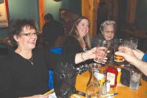 The Birch Grove Community School held its annual benefit at Papa Charlie’s at Lutsen Mountains on Friday, November 16. The benefit is a fun family event for kids of all ages. Above: Some “kids” make a toast to Birch Grove. Right: Everyone pitches in to serve a delicious dinner. Birch Grove Community School Administrator Diane Blanchette with a tray full of scrumptious lasagna. Below: D’Merritt donated their time and musical talents and rocked the Papa Charlie’s stage— much to the delight of Birch Grove kids and their parents.