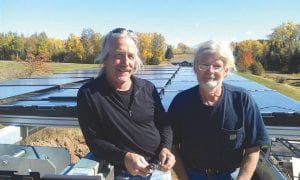 Brian Bennett of Outback Solar Electric and Randy Hodel of Randy Hodel Inc. pause in their work to talk about the solar array they installed at the Gunflint Hills Golf Course this fall. Once broadband is installed, a website will be set up to show the system’s performance.