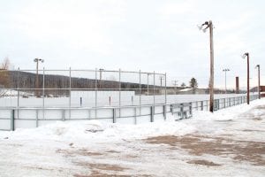 The new Grand Marais hockey rink is done and being flooded so it can be used this winter. The player bench area on the north side of the rink was built off-center to work with the location of existing lighting, but the Cook County Hockey Association subsequently paid to put in more lighting and will be paying to move the bench area to the center of the rink.