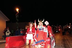 Grand Marais rang in the holiday season with a parade on Friday, November 23. Top left: SuperAmerica won the “Best Theme” prize for its Julefest float featuring St. Lucia, MaeAnna LaFavor (left), and Lynn Schulte. Top right: Joynes Department Store won the grand prize traveling trophy with their gnome-filled float. Lower left: There are always fire trucks in the parade and Grand Marais firefighter Matt Conlan brought along a tiny Christmas firefighter to smile and wave. Lower right: Dockside Fish Market won the “Cutest Kids” prize.