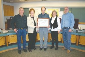 On November 27, the county made two bond sales totaling $11,835,000. The county got excellent interest rates, partly because it achieved a Standard & Poor’s credit rating of AA-. Ehlers & Associates, the consulting firm that handled the bond sale for the county, presented the board with a certificate recognizing this achievement. (L-R) Commissioner Fritz Sobanja, Carolyn Drude of Ehlers, County Auditor-Treasurer Braidy Powers, Commissioner Jan Hall, and Commissioner Bruce Martinson.