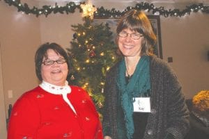 Above left: Care Partners Clinical Care Coordinator Jeanette Lindgren and Director Kay Grindland served as hosts for the event, making everyone feel welcome and cared for. Above: Rev. Mary Ellen Ashcroft offered a meaningful prayer and a touching benediction. Left: After the tree was lit at the November 29, everyone joined in singing Amazing Grace and Silent Night.