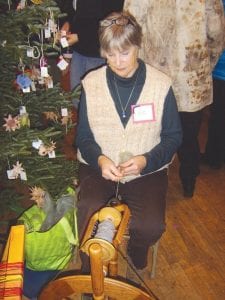 As the Grand Marais Art Colony opened its doors on Saturday, December 1, there was a long line of people eager to see the wonderful works of the Northwoods Fiber Guild. Throughout the day there were beautiful items for sale and many fiber guild members demonstrating their craft. Pat Zankman shows her spinning technique.