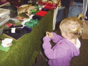 There were many delightful holiday gifts and crafts at the Christmas Craft and Bake Sale at the Evangelical Free Church on Saturday, December 1. This little girl was among the many happy shoppers.