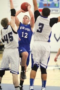 Colin Everson has emerged as the Vikings' go to scorer early in the season. He has averaged 28 points over the Vikings' first two wins. Above, Colin shoots over two defenders from South Range in Tuesday's game against the South Ridge Panthers.