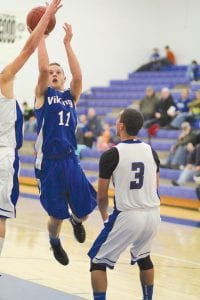 Above left: Kale Boomer busted through the lane and shot a floater over the South Ridge Panther defensive player's outstretched hand hitting nothing but net. Above