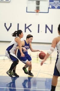 Above left: With the defender on her back—literally--Breana Peterson drives into the lane against the South Ridge Panthers and hits a lay-up. Far right: Just a ninth grader, Lily Gruber- Schulz won not only this jump ball, but also she won the battle of the glass. Lily grabbed12 defensive rebounds and 8 offensive rebounds to tally an outstanding 20 boards for the game against South Ridge. Right: Sweet shooting senior forward Theresa Morrin led the Vikings with 14 points against the South Ridge Panthers. Morrin also had several assists and played a very good game defensively against the Panthers.