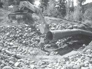 The Ullr Tightline project is the largest of four Great Lake Commission grant projects intended to reduce sediment into the Poplar River at Lutsen Mountains. Engineers estimate that the project will reduce sediment by 90 tons per year and will be able to handle a 100- year rain storm. Above: This giant pipe is part of the project and it is designed to help slow down the energy of the water flowing down the hill. Left: Riprap has been installed along the channel that discharges into the Poplar River. Riprap works by absorbing and deflecting the energy of the water flow before it reaches the streambed.