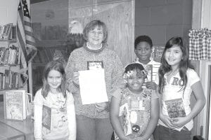 Dianne Schwecke, a retired librarian, volunteers her time each week at Birch Grove Community School. Schwecke started at Birch Grove last year and continues to be the school librarian. She is pictured here during student library time, holding a letter from Library Friends of Cook County awarding the library $500. Schwecke will use the funds to repair books, label books with Accelerated Reading program stickers and add additional books to the Birch Grove library. Birch Grove Administrator Diane Blanchette said, “Thank you to both Mrs. Schwecke and Friends of the Library for contributing to our school! We couldn’t do it without you!”