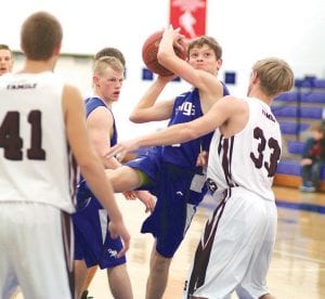 Above: Rory Bakke hauled in a rebound against Two Harbors' older, taller players. Just a 9th grader, Bakke is a scrappy player not afraid to rebound or chase any loose ball. Far right: Known more for his exploits on the football field, Peter Warren (33) has had a great senior year on the basketball court so far. Warren does all of the little things right, setting picks, rebounds and plays tough defense. Here he goes up for a rare shot against Two Harbors. Right: Richie Furlong urged the ball to go in as he shot it. Furlong scored 5 points against Two Harbors.