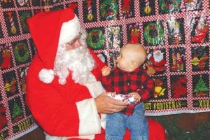 The American Legion Post 413 Auxiliary hosted its annual Christmas Carnival on Sunday,December 9. Kids enjoyed visiting with Santa Claus, although eight-month-old Christianwasn’t quite sure what to think of the bearded fellow. (Staff photos/Rhonda Silence)