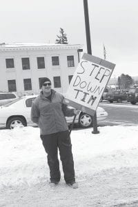 In an effort to get County Attorney Tim Scannell to resign from his position because of his involvement with a teenaged girl, Gary Nesgoda of Grand Marais stood on the street in front of the courthouse on Friday, December 14 with a hand-lettered sign (attached to a snow shovel handle) stating, “STEP DOWN TIM.”