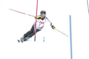 Left: Senior Signe Larson placed third in the girls' slalom race and led the Viking girls' team to a third place finish out of eight teams. Above: Anders Zimmer had a great second run but missed a gate on his first run and had to go back and go around it, losing precious time. Although he had an off day, the deep boys' team still had enough firepower to place first in the eight-team meet.