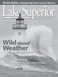 This photo of a powerful wave rolling over the Grand Marais lighthouse was taken by Grand Marais photographer Paul Sundberg. It graces the award-winning February/ March issue of Lake Superior Magazine.