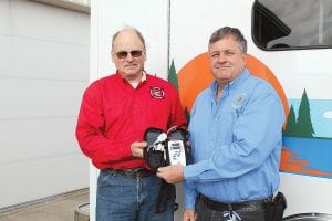 Terry Spieker of the Hovland Fire Department presents a Masimo Rad57 Oximeter to Cook County Ambulance Director Steve DuChien. The medical device, which tests for the presence of carbon monoxide in a patient’s bloodstream, will be kept by the ambulance service to be used wherever needed throughout the county. The Hovland Fire Department found the funding to purchase the muchneeded monitor. Left: The small oximeter will be a big help to area emergency responders.